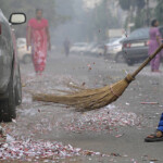 NOIDA, INDIA - OCTOBER 31: A sweeper cleaning the road littered with burst fire-crackers on Diwali night on October 31, 2016 in Noida, India. The roads of the city get very dirty with remains of firecrackers, flowers, puja samagri etc. (Photo by Sunil Ghosh/Hindustan Times via Getty Images)